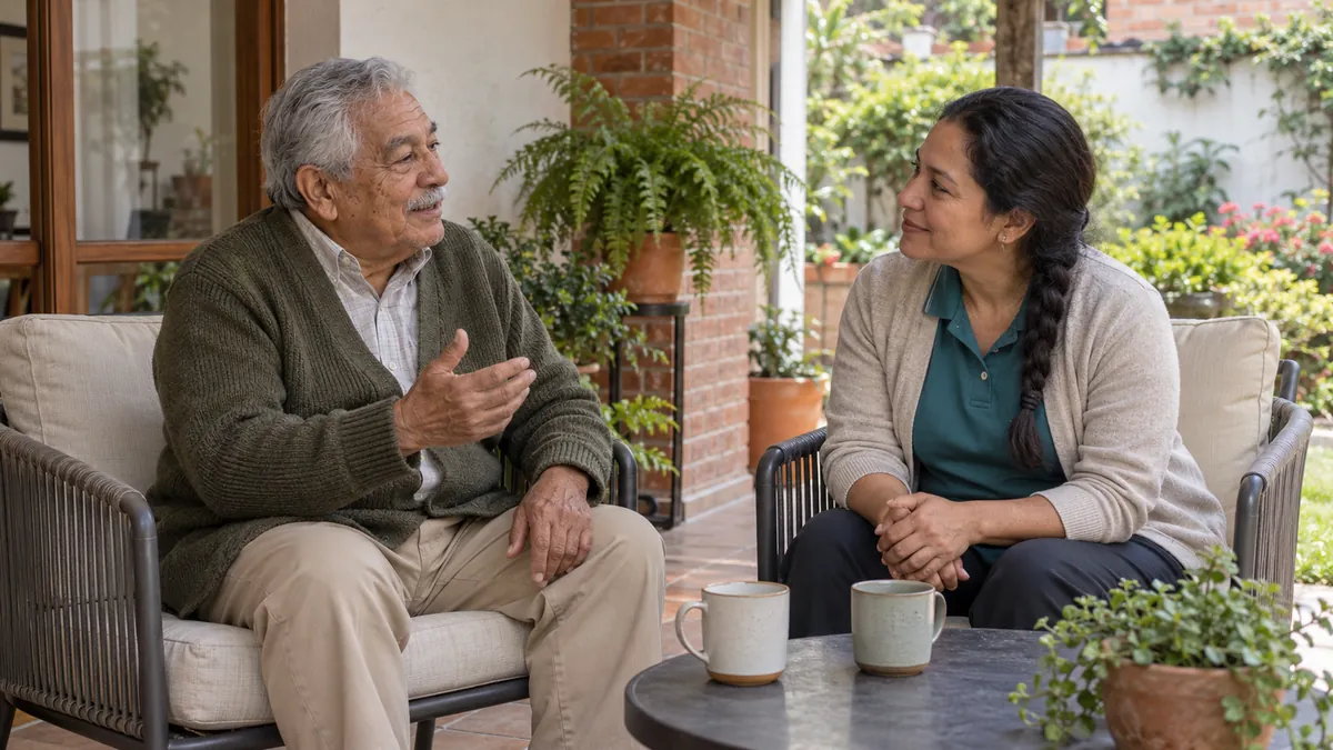 Ilustración: un señor mayor conversa con su acompañante en el patio de su casa, con dos tazas de café en la mesa.